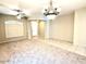 Open-concept living room with large windows and elegant chandelier, perfect for entertaining or relaxation at 4286 E Buckboard Rd, Gilbert, AZ 85297
