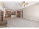 Open-concept living room showcasing a fireplace, seamlessly connecting to the kitchen and dining area at 4286 E Buckboard Rd, Gilbert, AZ 85297