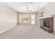 Spacious living room featuring a cozy fireplace, built-in shelves, and ample natural light from the window at 4286 E Buckboard Rd, Gilbert, AZ 85297