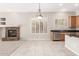 Spacious living room with tile flooring, a fireplace, and a view into the kitchen at 4286 E Buckboard Rd, Gilbert, AZ 85297