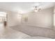 Bright, open living area with plush carpeting, tile entryway, ceiling fans, and natural light at 4286 E Buckboard Rd, Gilbert, AZ 85297