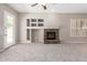 Expansive living room showcasing a brick fireplace, built-in shelving, and access to the outdoor area at 4286 E Buckboard Rd, Gilbert, AZ 85297