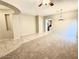 Open-concept living room showcasing a seamless transition from carpeted living space to tiled entrance area at 4286 E Buckboard Rd, Gilbert, AZ 85297