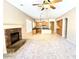 Bright living room featuring a cozy fireplace, an open-concept design, and direct access to the kitchen at 4286 E Buckboard Rd, Gilbert, AZ 85297