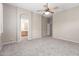 Carpeted primary bedroom with natural light, ensuite access, and a ceiling fan for added comfort at 4286 E Buckboard Rd, Gilbert, AZ 85297