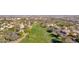 Aerial view of a community on a golf course with many residential homes and green fairways at 5018 E Siesta Dr # 3, Phoenix, AZ 85044