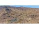 An aerial shot of a parking lot and desert hills featuring a winding dirt road at 5018 E Siesta Dr # 3, Phoenix, AZ 85044