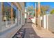 Backyard view with a tiled patio, palm trees, lush landscaping, and a glimpse of the home's interior at 5018 E Siesta Dr # 3, Phoenix, AZ 85044