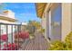 A balcony with wood floors and wrought iron railings, decorated with colorful flowers and potted plants at 5018 E Siesta Dr # 3, Phoenix, AZ 85044
