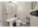 Powder room featuring a pedestal sink, toilet, and decorative accents, offering a clean and functional space at 5018 E Siesta Dr # 3, Phoenix, AZ 85044