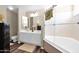 Bathroom featuring double sinks, a large mirror, and a shower over a soaking tub with glass doors at 5018 E Siesta Dr # 3, Phoenix, AZ 85044