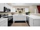 Well-lit kitchen featuring white cabinetry and modern appliances at 5018 E Siesta Dr # 3, Phoenix, AZ 85044