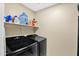 Functional laundry room with a modern washer and dryer set, storage shelves, and ample space for laundry tasks at 5018 E Siesta Dr # 3, Phoenix, AZ 85044