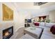 Open-concept living area with fireplace, TV, and stairs leading to upper level at 5018 E Siesta Dr # 3, Phoenix, AZ 85044