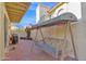 Tiled patio with a covered swing, grill, and lush landscaping at 5018 E Siesta Dr # 3, Phoenix, AZ 85044