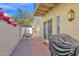 Tiled patio featuring a covered grill, swing, and slider access to the home at 5018 E Siesta Dr # 3, Phoenix, AZ 85044