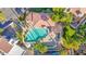 Aerial view of a turquoise pool featuring a covered patio area, lounge chairs, and palm trees at 5018 E Siesta Dr # 3, Phoenix, AZ 85044