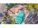 Aerial view of a pool with a covered seating area and multiple lounge chairs surrounded by palm trees at 5018 E Siesta Dr # 3, Phoenix, AZ 85044