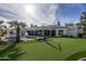 Expansive backyard with a pool, putting green, lounge chairs, and landscaping offers space for relaxation and recreation at 5045 N 22Nd St, Phoenix, AZ 85016