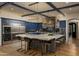 A wide view of the kitchen with a large center island, custom cabinetry, and stylish lighting fixtures at 5045 N 22Nd St, Phoenix, AZ 85016