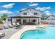 Inviting backyard features a sparkling pool, spa, covered patio with ample seating, and outdoor kitchen with BBQ grill at 5101 E Winchcomb Dr, Scottsdale, AZ 85254