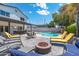 Wonderful backyard with lounge chairs, dining table, fire pit, and pool offers resort style relaxation at 5101 E Winchcomb Dr, Scottsdale, AZ 85254