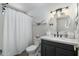 Clean bathroom featuring shower with curtain, and vanity with round mirror at 5101 E Winchcomb Dr, Scottsdale, AZ 85254