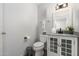 Bright bathroom with a vanity with drawers, toilet, and a mirror above the sink at 5101 E Winchcomb Dr, Scottsdale, AZ 85254