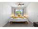 Cozy bedroom features a decorative bed, ceiling fan, and abundant natural light at 5101 E Winchcomb Dr, Scottsdale, AZ 85254