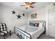 Bright bedroom with a decorative bed, ceiling fan, and unique wall decor at 5101 E Winchcomb Dr, Scottsdale, AZ 85254