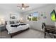 Cozy bedroom featuring a patterned bedspread, side table, and window at 5101 E Winchcomb Dr, Scottsdale, AZ 85254