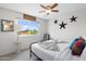 Well-lit bedroom featuring a comfortable bed, window view, and unique decorations at 5101 E Winchcomb Dr, Scottsdale, AZ 85254
