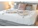 Bedroom features a gray bed frame, white duvet, and various decorative pillows and blanket at 5101 E Winchcomb Dr, Scottsdale, AZ 85254