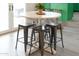 Eat-in kitchen breakfast nook boasts a round table, four stools, and a view into a modern kitchen at 5101 E Winchcomb Dr, Scottsdale, AZ 85254