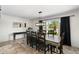 Bright dining room featuring a large window, wood table, and tile floors at 5101 E Winchcomb Dr, Scottsdale, AZ 85254
