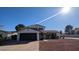 Traditional two-story home boasts a well-maintained front yard, two-car garage, and classic architectural details at 5101 E Winchcomb Dr, Scottsdale, AZ 85254