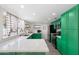 Modern kitchen featuring bold green cabinets, quartz countertops, stainless steel appliances, and ample storage at 5101 E Winchcomb Dr, Scottsdale, AZ 85254