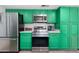 Modern kitchen features bright green cabinets, stainless steel appliances, and stylish countertops at 5101 E Winchcomb Dr, Scottsdale, AZ 85254