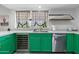 Stylish kitchen with bold green cabinetry, quartz countertops, stainless steel appliances, and modern finishes at 5101 E Winchcomb Dr, Scottsdale, AZ 85254