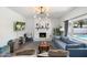 Bright living room with a brick fireplace, modern lighting, and comfortable seating offers a relaxing atmosphere at 5101 E Winchcomb Dr, Scottsdale, AZ 85254