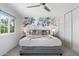 Relaxing main bedroom featuring a decorative accent wall, ceiling fan, and modern decor at 5101 E Winchcomb Dr, Scottsdale, AZ 85254