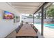 Outdoor patio features a long table with seating, an outdoor TV, and a view of the pool at 5101 E Winchcomb Dr, Scottsdale, AZ 85254