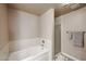Clean bathroom with a bathtub, tiled walls, shower with glass door, and towel racks at 5450 E Deer Valley Dr # 2193, Phoenix, AZ 85054