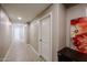 Well-lit hallway with tile flooring, neutral walls, and decorative wall art at 5450 E Deer Valley Dr # 2193, Phoenix, AZ 85054