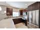 Stylish kitchen with stainless steel appliances, mosaic backsplash, and dark wood cabinetry at 5450 E Deer Valley Dr # 2193, Phoenix, AZ 85054