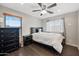 Cozy bedroom with ceiling fan, window, and hardwood floors provides natural light and comfort at 5936 W Park View Ln, Glendale, AZ 85310