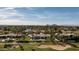 Stunning aerial view of a luxury home with pool, golf course, and city skyline at 6302 E Hillcrest Blvd, Scottsdale, AZ 85251