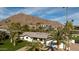 An aerial view showcases this home's lush landscaping and breathtaking mountain views at 6302 E Hillcrest Blvd, Scottsdale, AZ 85251