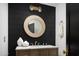Modern powder room with a round mirror and dark wood vanity at 6302 E Hillcrest Blvd, Scottsdale, AZ 85251