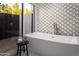 Bright bathroom showcasing a modern freestanding tub, bronze fixtures, and glass enclosed shower at 6302 E Hillcrest Blvd, Scottsdale, AZ 85251